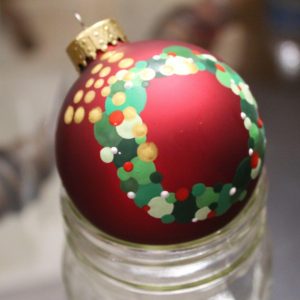 Hand painted Christmas ornament with a wreath.