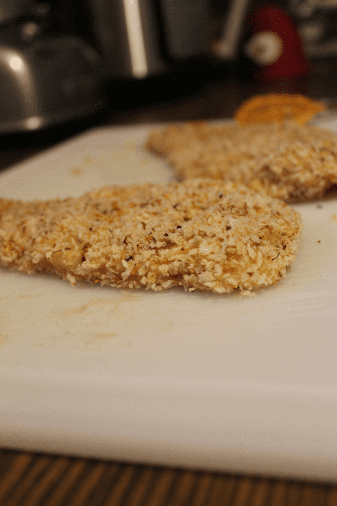 breaded chicken on cutting board