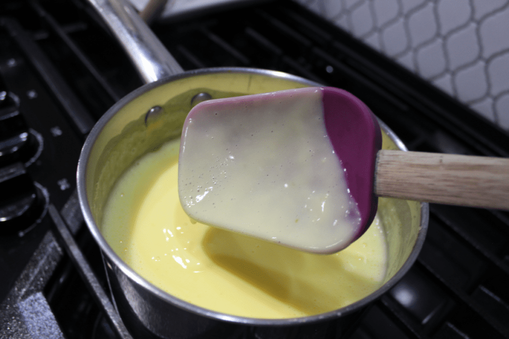 Custard is sticking to the spoon so it is ready