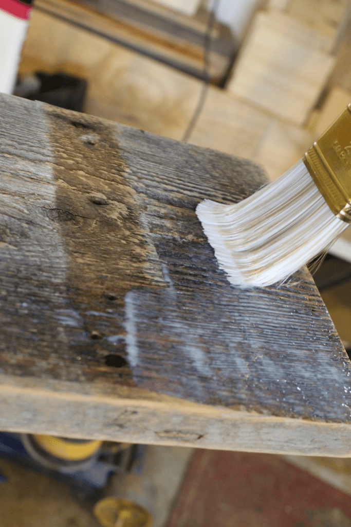 brushing on the polyurethane to the barnwood