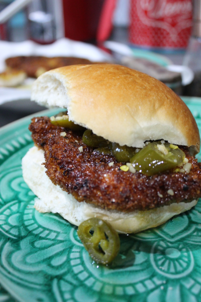 portrait of fried chicken sandwich with jalapeno topping