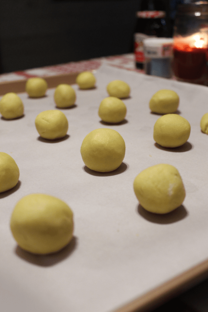 roll dough balls and place on lined cookie sheet